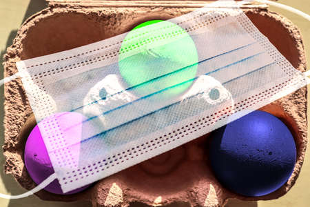 Colorful Easter Eggs in a box covered in masks during lockdown in Germanyの写真素材