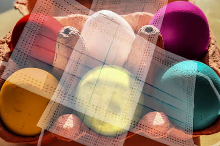 Colorful Easter Eggs in a box covered in masks during lockdown in Germany