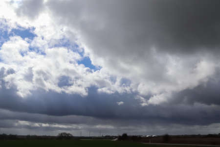 Beautiful clouds in a dark sky over a northern european landscape