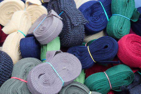 Detailed close up view on samples of zippers in different colors found at a fabrics market.