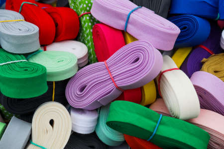 Detailed close up view on samples of zippers in different colors found at a fabrics market.の写真素材