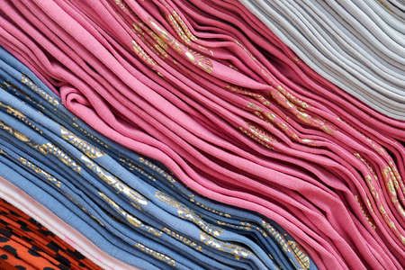 Detailed close up view on samples of cloth and fabrics in different colors found at a fabrics market.の写真素材