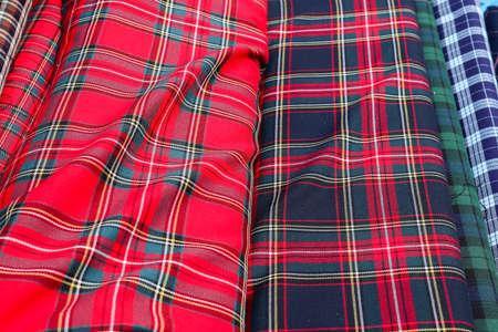 Detailed close up view on samples of cloth and fabrics in different colors found at a fabrics market.の写真素材