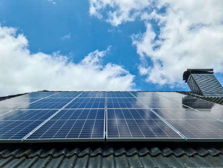 Solar panels producing clean energy on a roof of a residential house