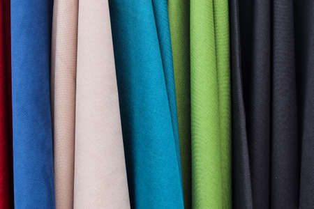 Detailed close up view on samples of cloth and fabrics in different colors found at a fabrics...