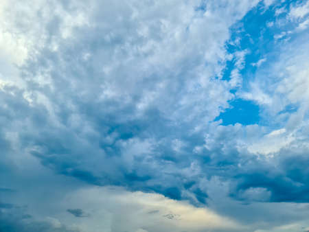 Beautiful fluffy white beautiful cloud formations in a deep blue summer skyの写真素材
