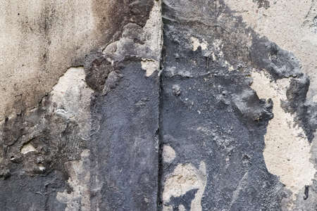 Wall in a steel mill with clear signs of use, cracks and pipes. High resolution background