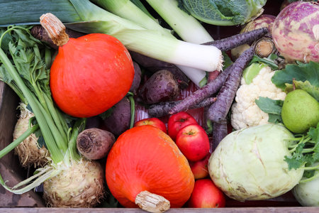 A pile of mixed and healthy vegetables at a marketの写真素材