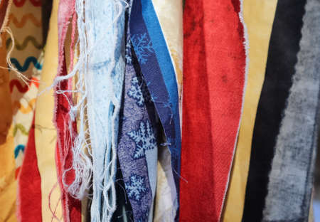 Detailed close up view on samples of cloth and fabrics in different colors found at a fabrics...