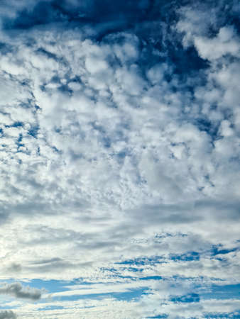 Beautiful fluffy white beautiful cloud formations in a deep blue summer skyの写真素材