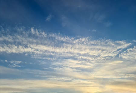 Beautiful panorama of orange and yellow clouds at sunrise and sunset in a blue sky