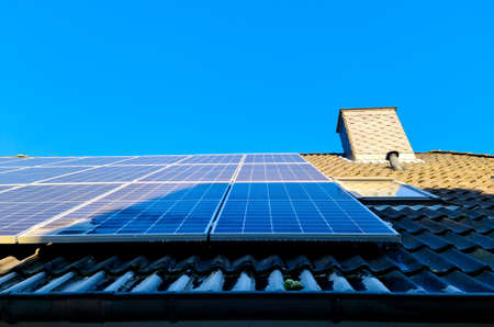 Solar panels producing clean energy on a roof of a residential house