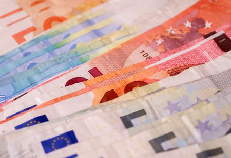 Close up of numerous euro banknotes lying on top of each otherの写真素材