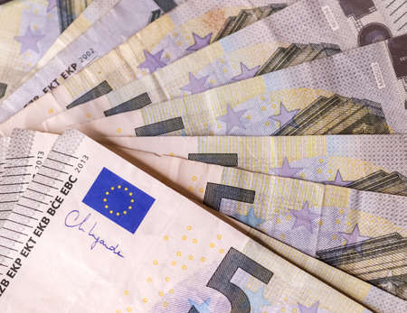 Close up of numerous euro banknotes lying on top of each otherの写真素材
