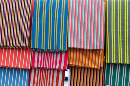 Detailed close up view on samples of cloth and fabrics in different colors found at a fabrics market.の写真素材