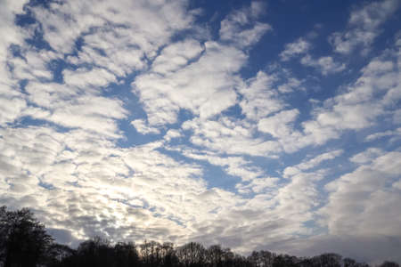 Beautiful fluffy white cloud formations in a deep blue summer sky