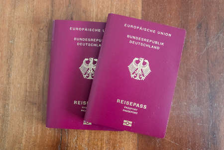 Two German passports on a wooden background for passport control