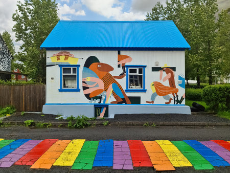 Seydisfjordur, Iceland - 23.June 2022: The famous rainbow road in Seydisfjordur with icelandic buildings around show artwork painted wallsのeditorial素材