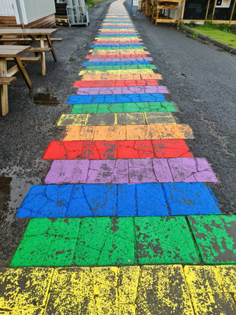 Seydisfjordur, Iceland - 23.June 2022: The famous rainbow road in Seydisfjordur with icelandic buildings around show artwork painted wallsのeditorial素材