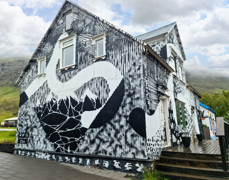 Seydisfjordur, Iceland - 23.June 2022: The famous rainbow road in Seydisfjordur with icelandic buildings around show artwork painted wallsのeditorial素材