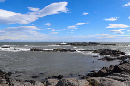 A surf on a rocky beach with black sand in Icelandの写真素材