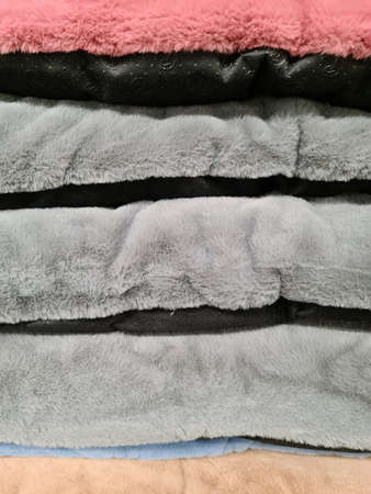 Detailed close up view on samples of cloth and fabrics in different colors found at a fabrics...