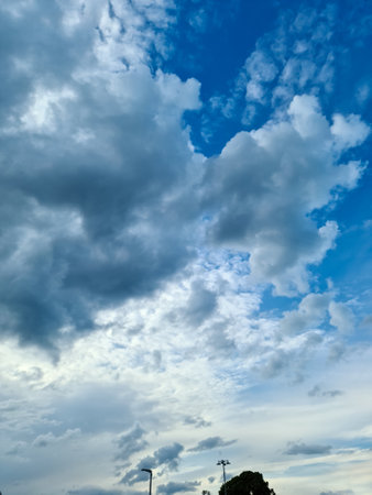 Beautiful fluffy white beautiful cloud formations in a deep blue summer skyの写真素材