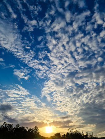 Beautiful fluffy white beautiful cloud formations in a deep blue summer skyの写真素材