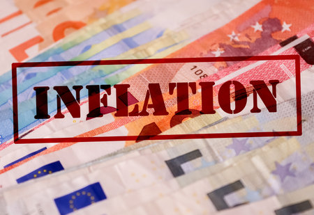 A stamp with the red lettering Inflation on numerous euro banknotes - Financial crisis concept in Germany and Europeの写真素材