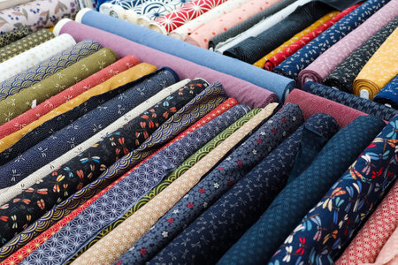 Detailed close up view on samples of cloth and fabrics in different colors found at a fabrics market.の写真素材