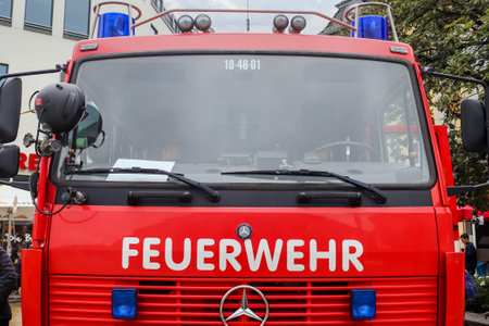 Neumuenster, Germany - 24.September 2022: Vehicles of the Neumuenster fire brigade with blue lights in front of the shopping centreのeditorial素材