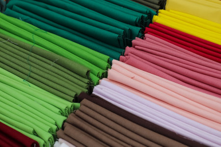 Detailed close up view on samples of cloth and fabrics in different colors found at a fabrics market.の写真素材