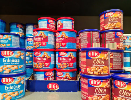 Kiel, Germany - 11 February 2023: Different varieties of Ueltje Lays brand peanuts on a supermarket shelf.のeditorial素材