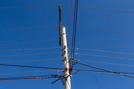 Wildly attached power cables to a power pole