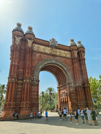 Barcelona, Spain - 22 July 2023: The Arc de Triomf in Barcelona on a sunny day with touristsのeditorial素材