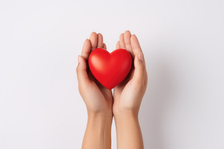 A human hand holding a heart isolated on a white background.の素材