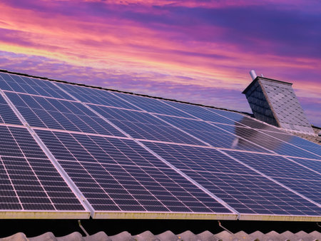 Solar panels producing clean energy on a roof of a residential houseの写真素材