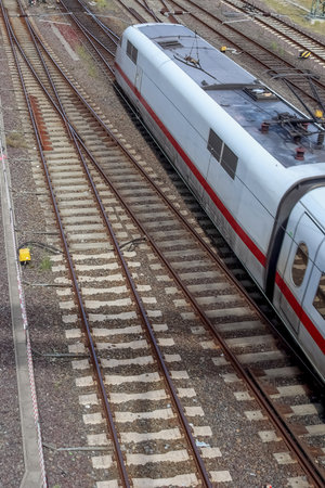 Multiple railroad tracks with junctions at a railway station in a perspective viewの写真素材