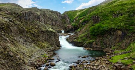 Long exposure of a waterfall in a rocky landscape in Iceland during fallの写真素材