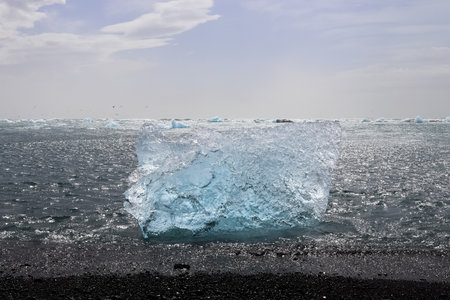 Chunks of ice and icebergs washed up from the glacier at the famous Glacier Lagoon in Icelandの写真素材