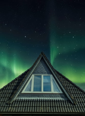 Open roof window in velux style with black roof tilesの写真素材