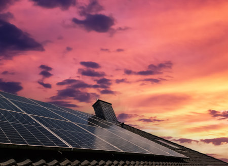 Solar panels producing clean energy on a roof of a residential houseの写真素材
