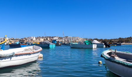 Marsaxlokk, Malta - 29. September 2024: View of small fishing boats in the harbor of Marsaxlokk on Malta in the sunshineのeditorial素材