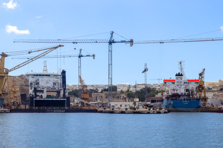 Valletta, Malta: 01. October 2024: Ships and cranes at the docks of the industrial port of Valletta in Maltaのeditorial素材
