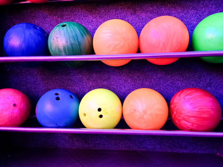 Rack of colorful bowling balls waiting to be chosen for a fun gameの写真素材