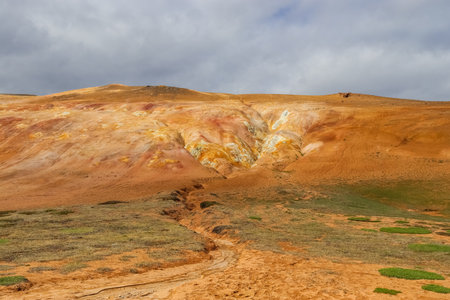 Rhyolite mountains and geothermal area with fumaroles and mud pots creating colorful slopes in icelandの写真素材