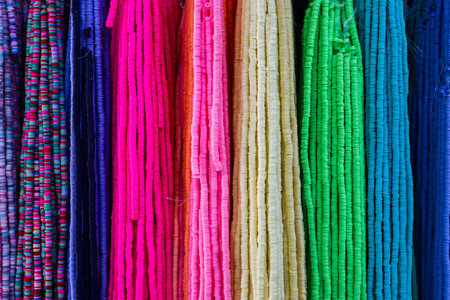 Strings of colorful beads create a vibrant and textured tapestry, showcasing a spectrum of hues and...