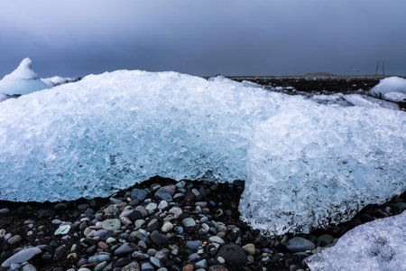 Ice from breidamerkurjokull glacier melting on diamond beach in iceland, creating beautiful shapes...