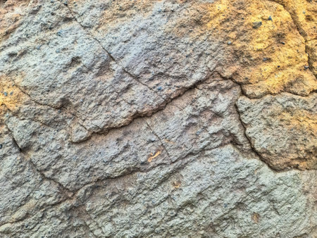 Detailed view of a cracked rock surface in Iceland, highlighting the geological formations and...