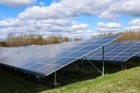 Rows of solar panels capturing sunlight in a field, generating sustainable electricity under a...